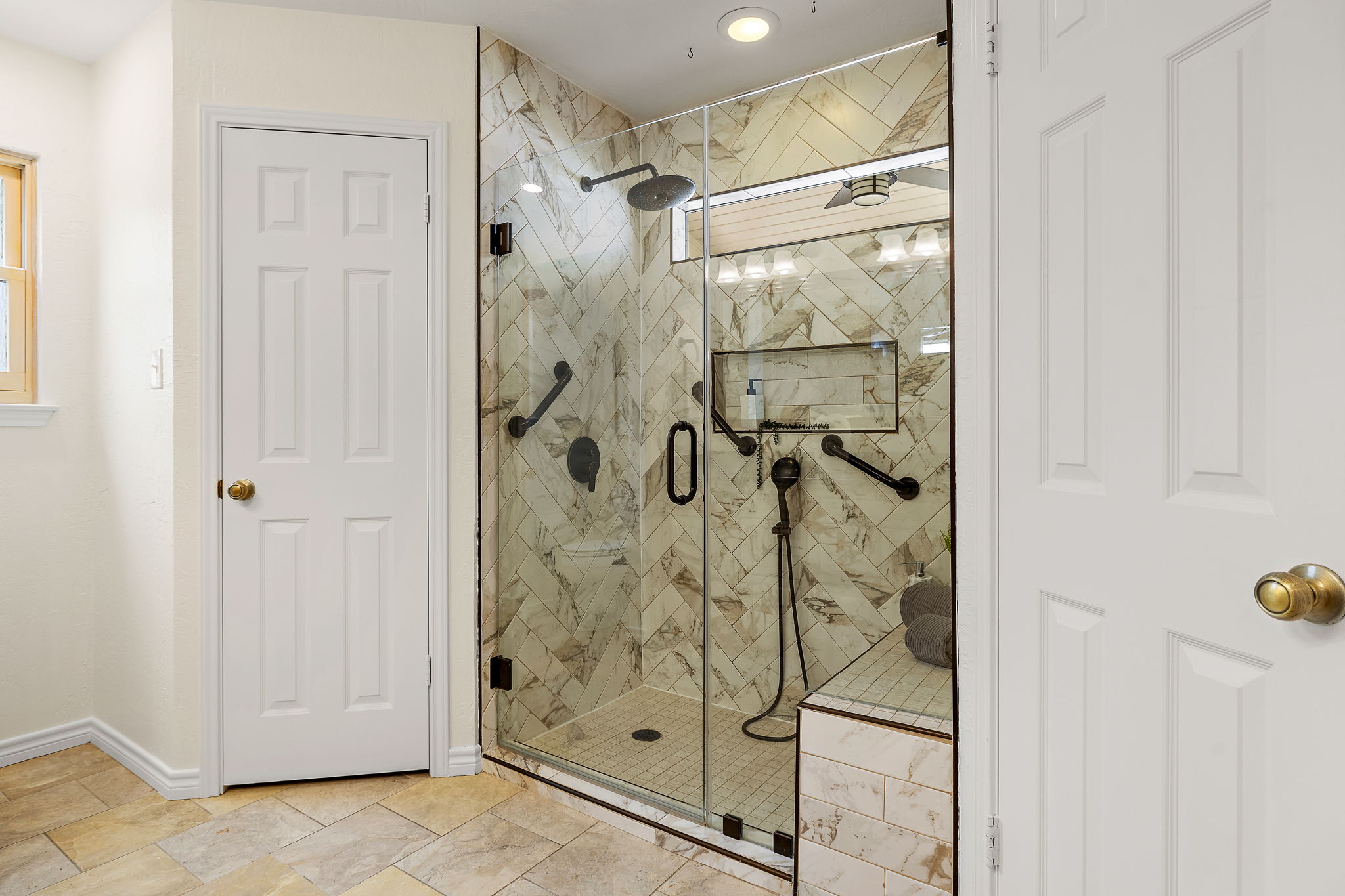 9002 Bancroft Trail Austin, TX 78729 - Photo 17 of 35 View of the walk-in shower with seating and two walk-in closets.