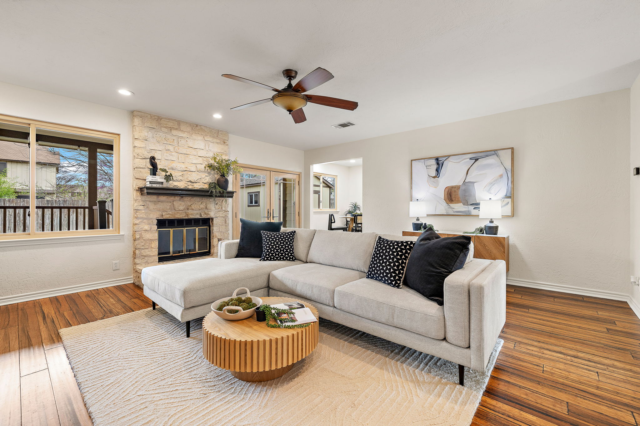 9002 Bancroft Trail Austin, TX 78729 - Photo 2 of 35 Massive living room with limestone fireplace, recessed lighting, bamboo flooring and ceiling fan.
