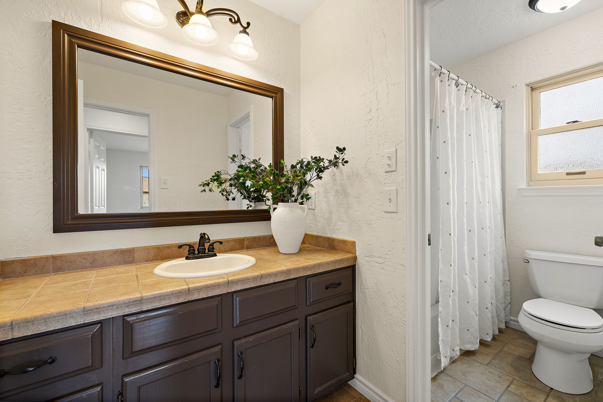 9002 Bancroft Trail Austin, TX 78729 - Photo 22 of 35 This is the secondary bathroom upstairs which conveniently has the shower and toilet separated by a door.