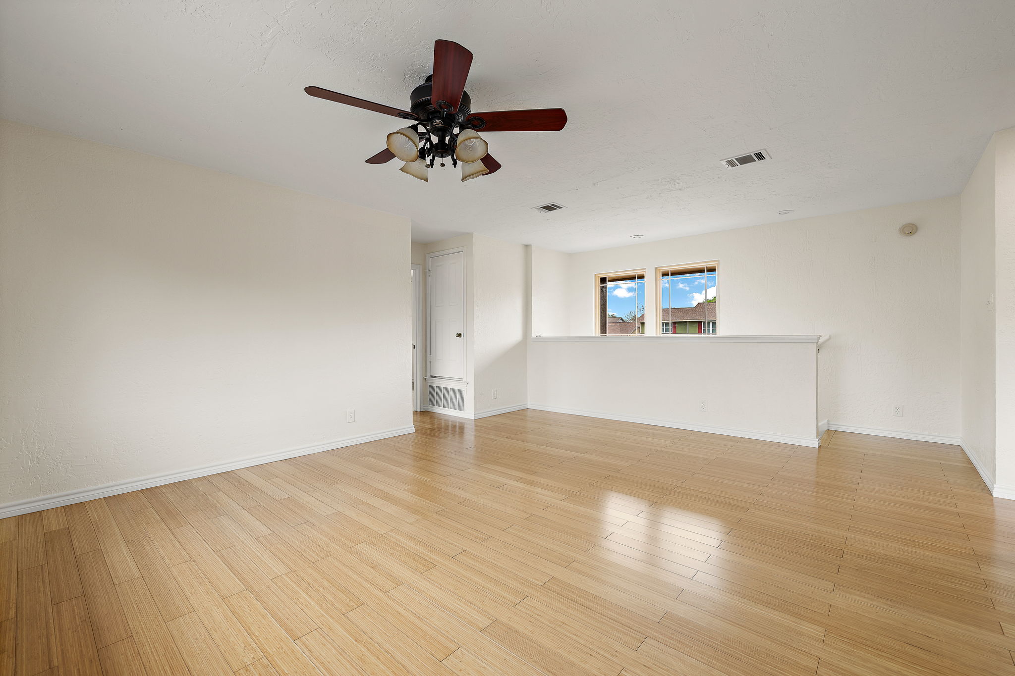 9002 Bancroft Trail Austin, TX 78729 - Photo 25 of 35 View of the second living area looking toward the hallway to two of the three upstairs bedrooms and the stairway. This versatile space could be a game room, family room, craft room, workout room, media room, etc.
