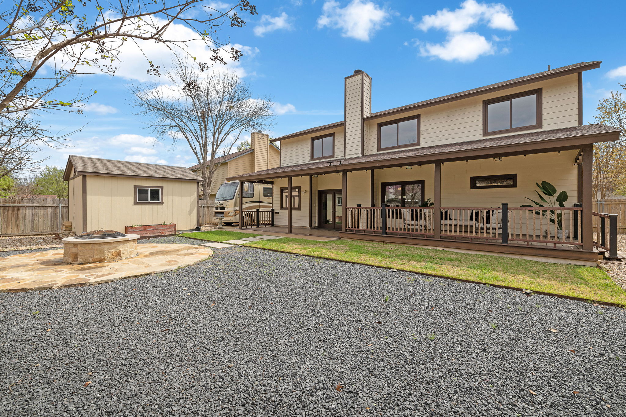 9002 Bancroft Trail Austin, TX 78729 - Photo 31 of 35 Hardly any lawn to mow in this backyard, but just enough for your pups! Look at that spacious covered patio! And the firepit gathering area! And the workshop!