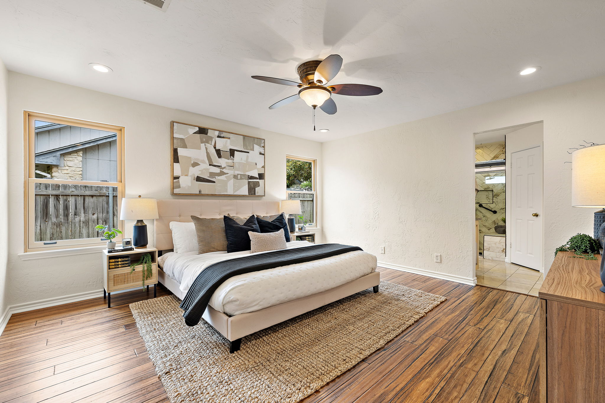 9002 Bancroft Trail Austin, TX 78729 - Photo 4 of 35 Generously-sized primary bedroom is located on the first floor. Dimmable recessed lighting and ceiling fan!