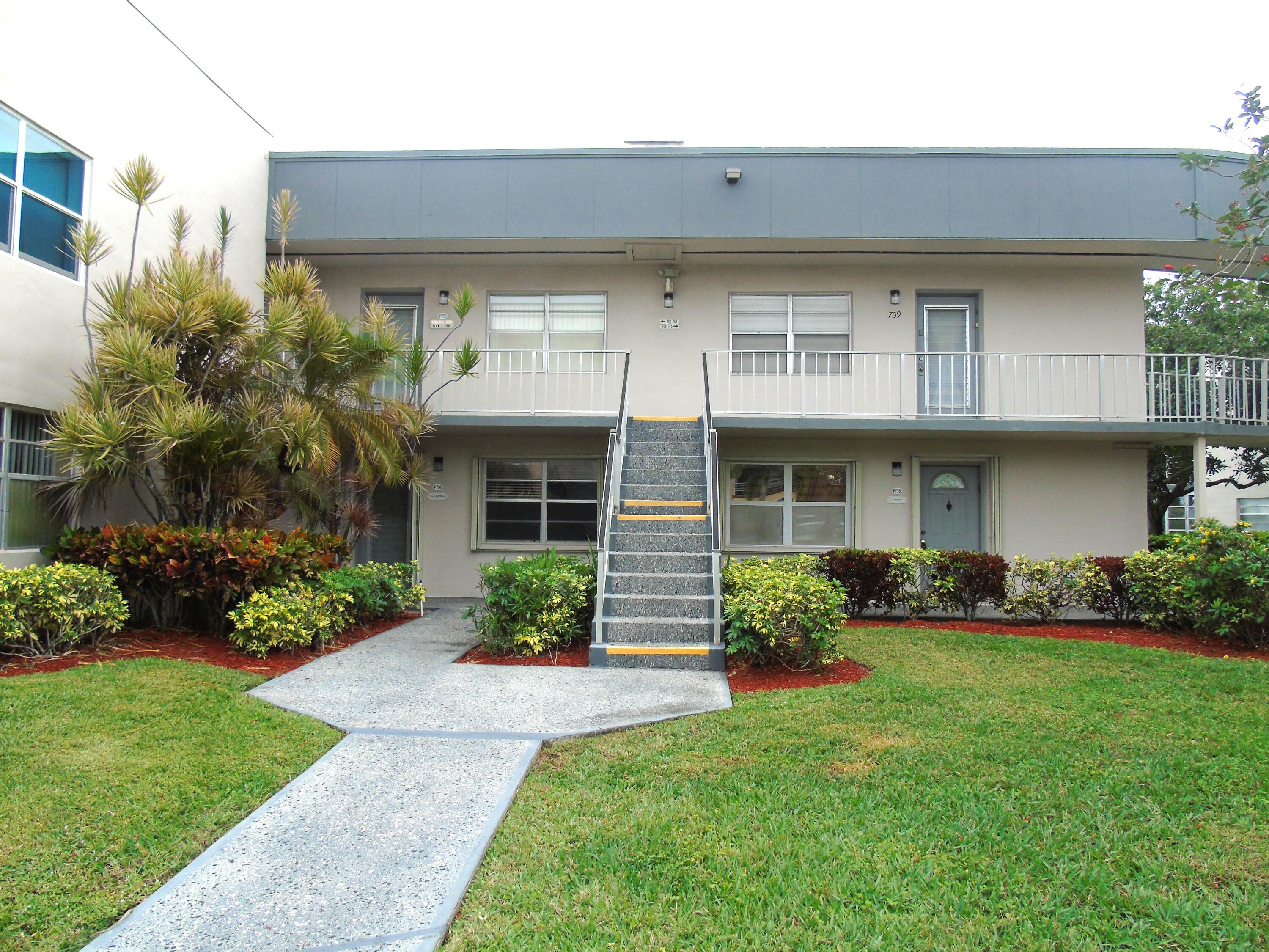 760 Burgundy P Delray Beach, FL 33484 - Photo 1 of 24 a front view of a house with a yard and garage