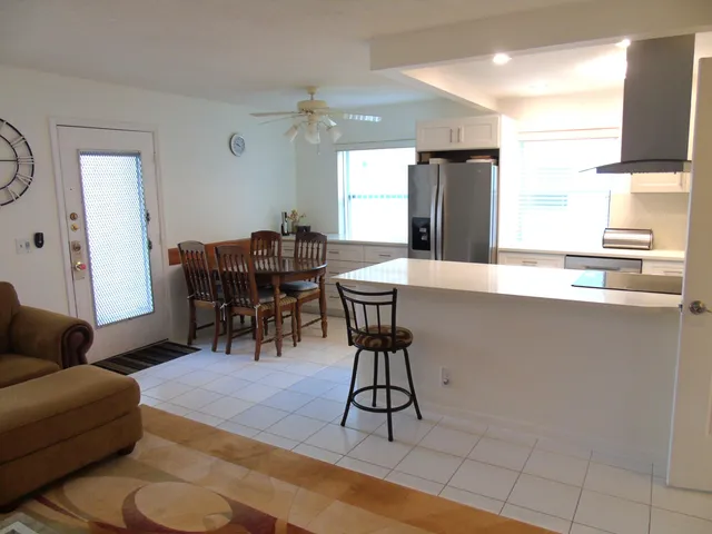 a living room with furniture a flat screen tv and a table