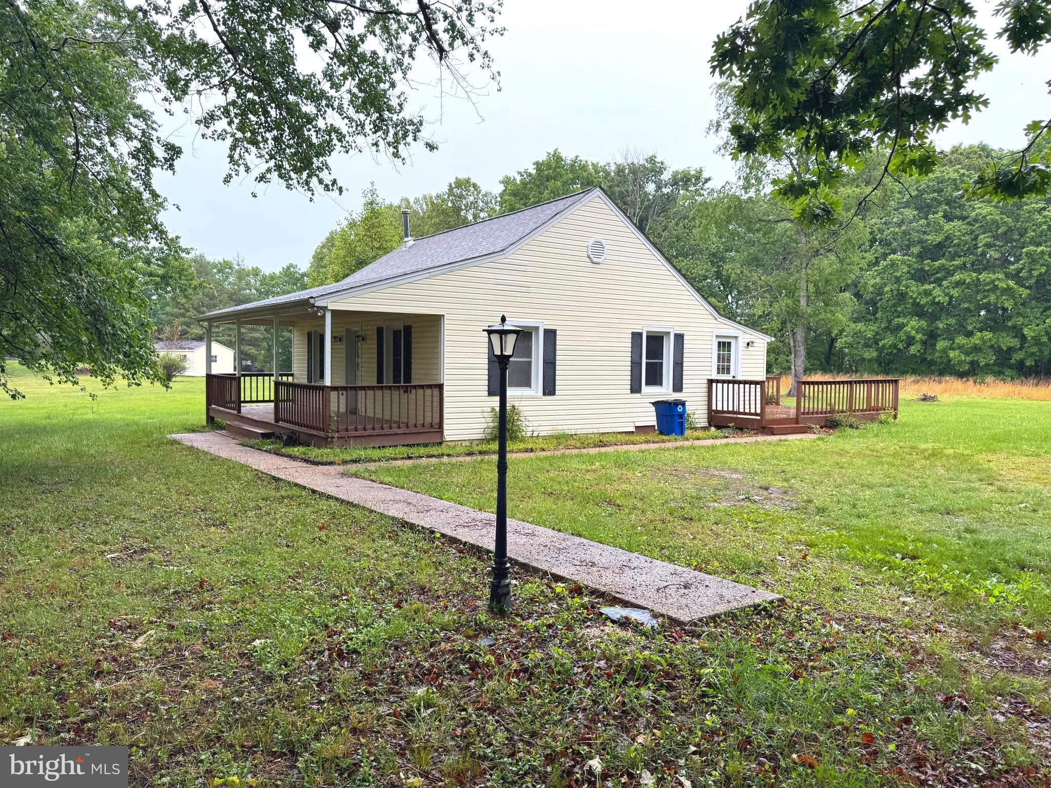 18163 Monrovia Road Orange, VA 22960 - Photo 1 of 15 a view of a house with a yard deck and a small cabin