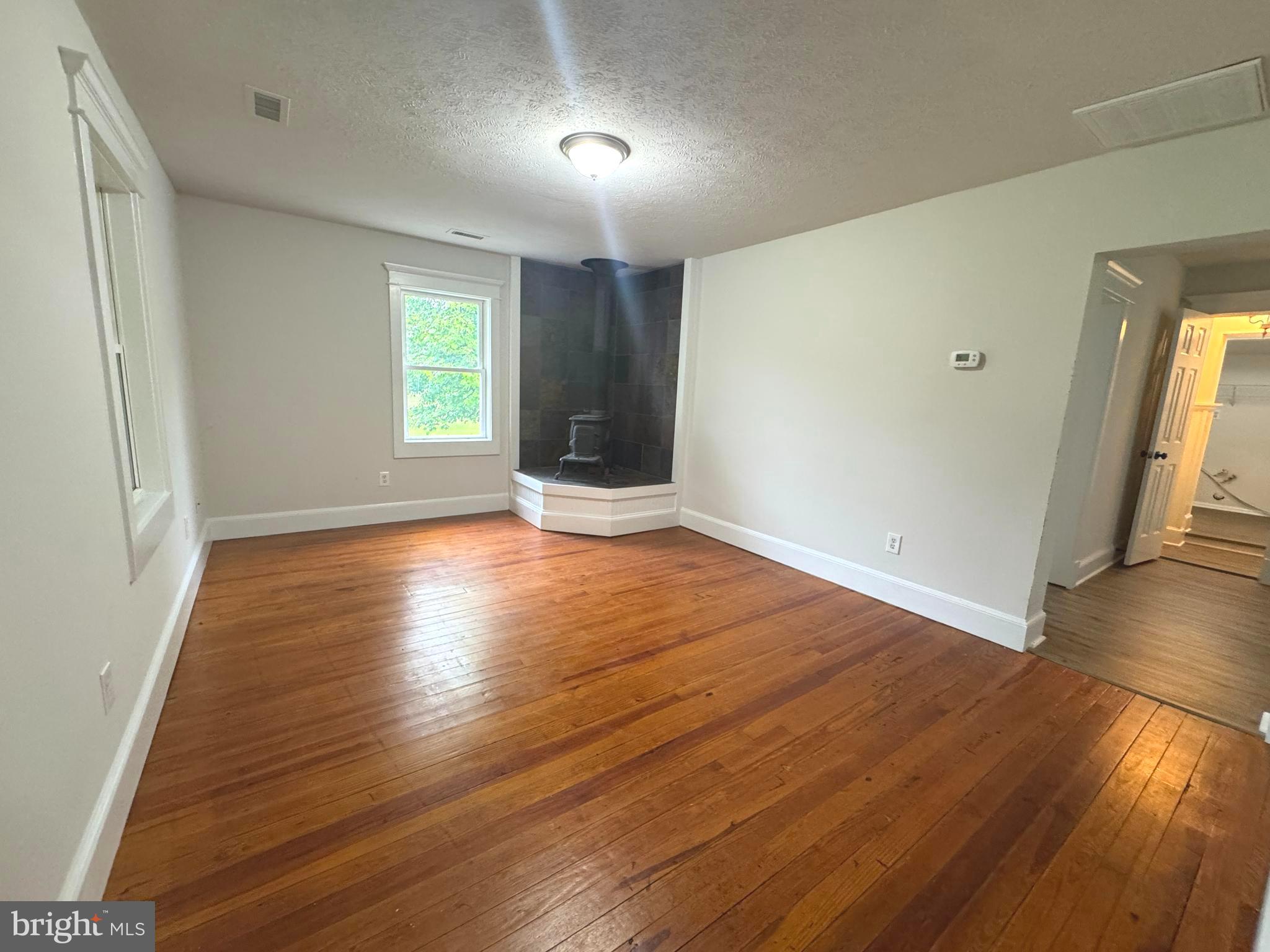 18163 Monrovia Road Orange, VA 22960 - Photo 4 of 15 an empty room with wooden floor and windows