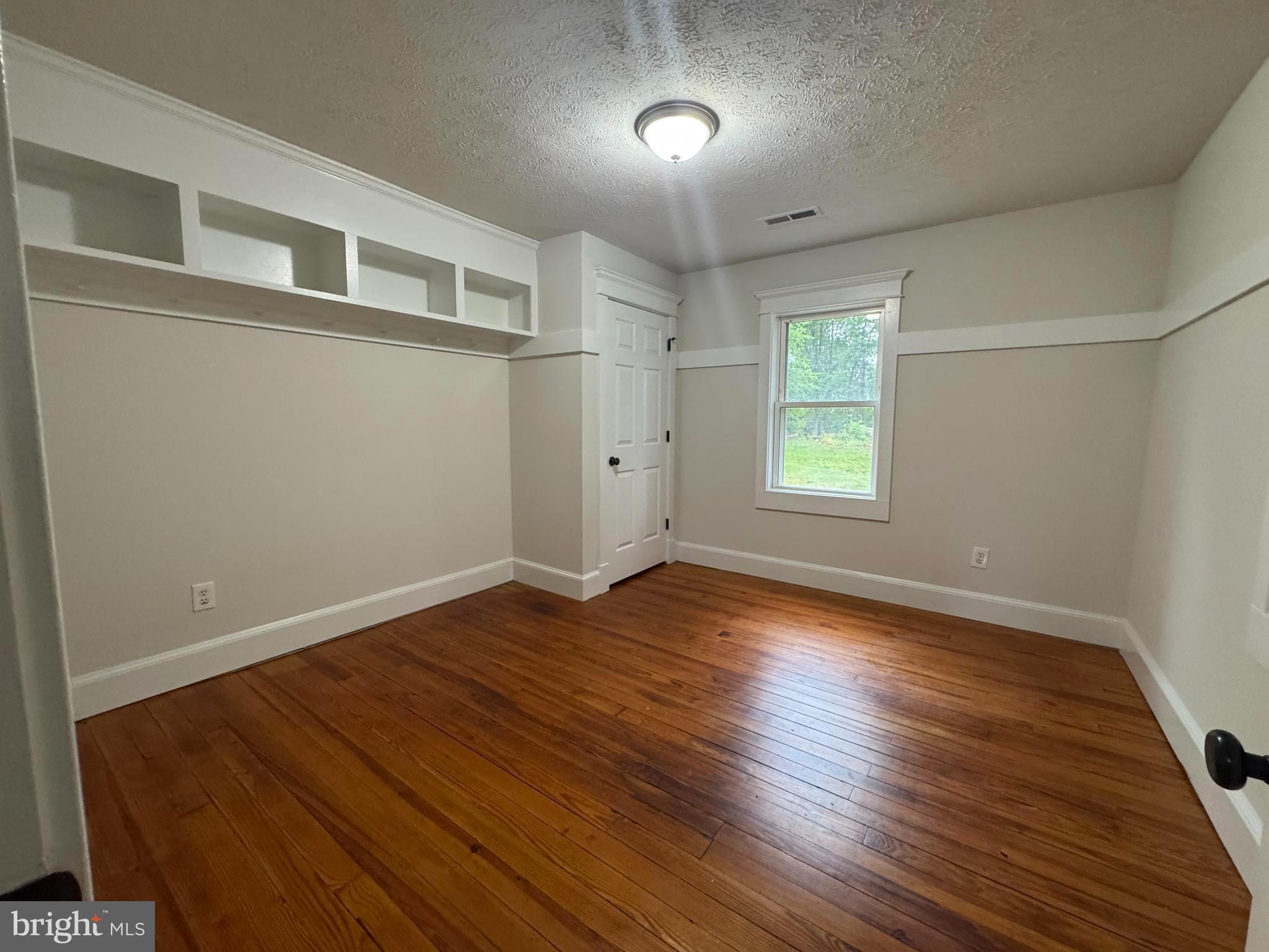 18163 Monrovia Road Orange, VA 22960 - Photo 5 of 15 an empty room with wooden floor and windows