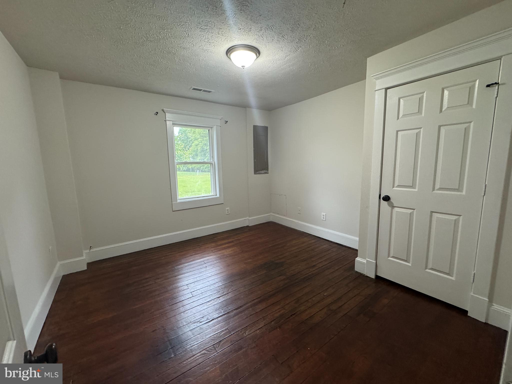 18163 Monrovia Road Orange, VA 22960 - Photo 6 of 15 an empty room with wooden floor and windows