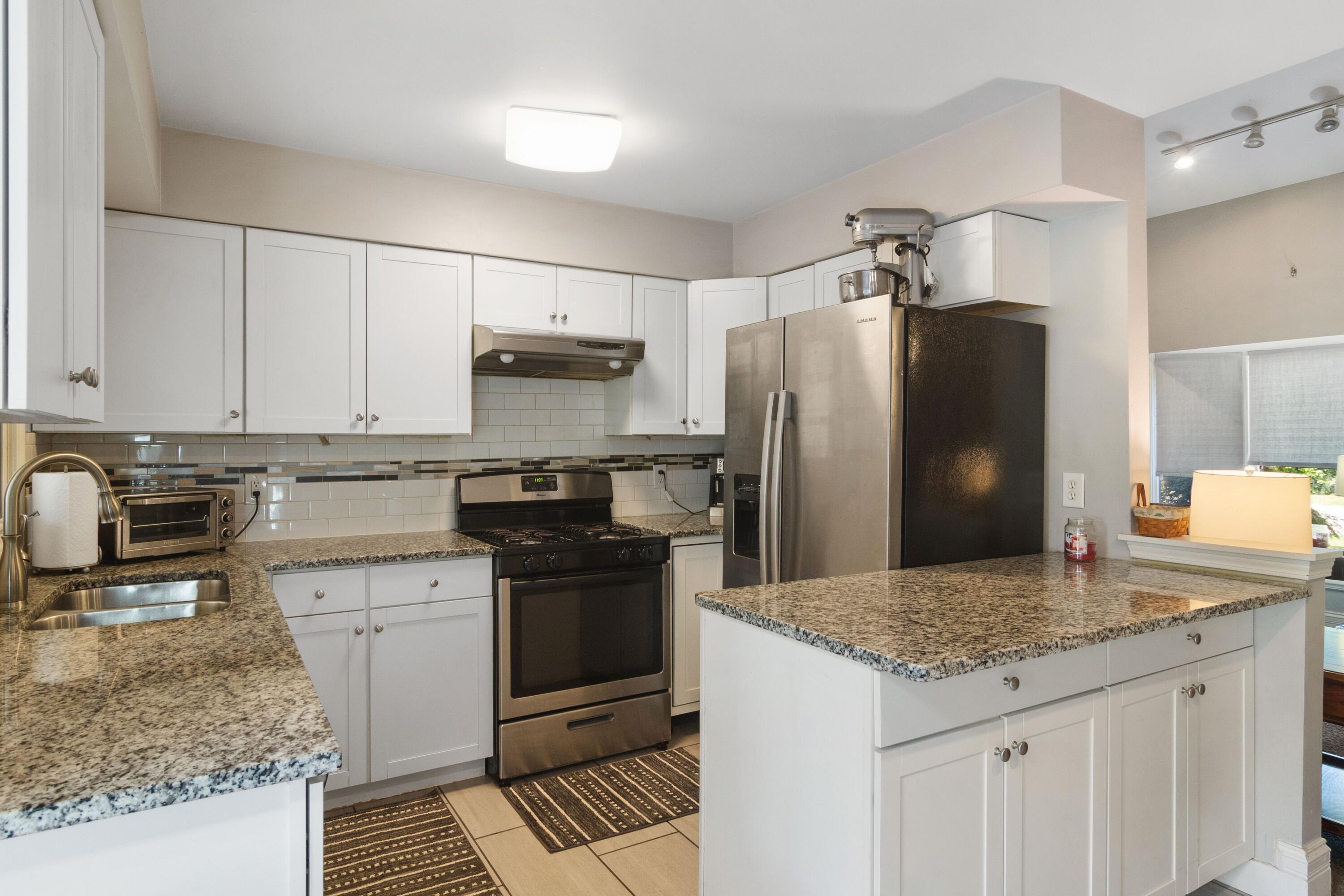 1847 Springvale Drive Crown Point, IN 46307 - Photo 5 of 22 a kitchen with kitchen island granite countertop a sink stove and refrigerator