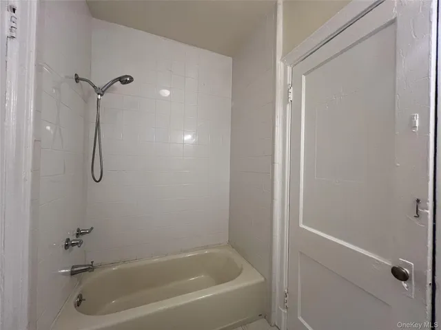 a bathroom with a bath tub with a shower