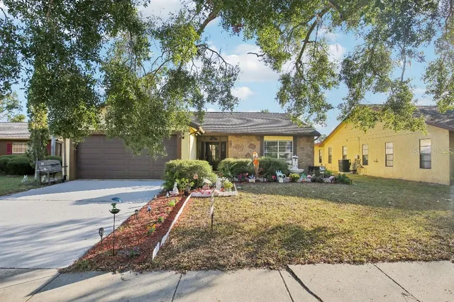 a front view of a house with yard patio and outdoor seating