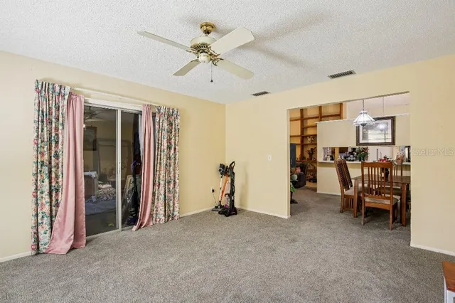 a view of a livingroom with furniture and a ceiling fan