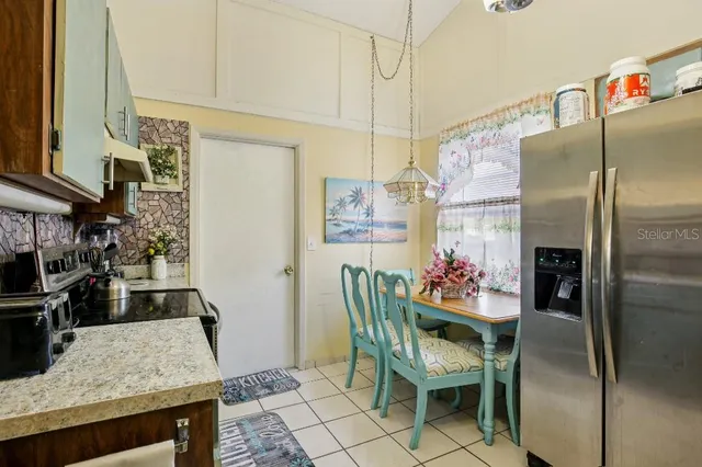 a kitchen with a table and chairs