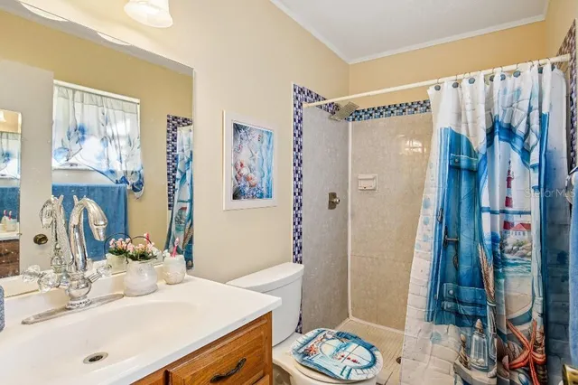 a bathroom with a sink a mirror and a shower