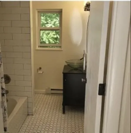 a bathroom with a granite countertop sink a toilet and bathtub