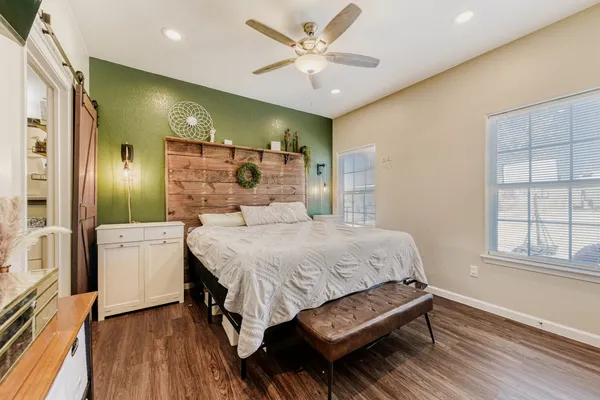 a spacious bedroom with a bed and a chandelier