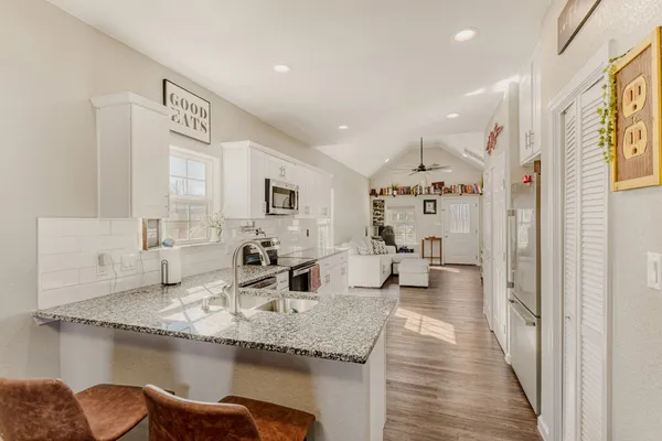 a kitchen with counter top space and windows