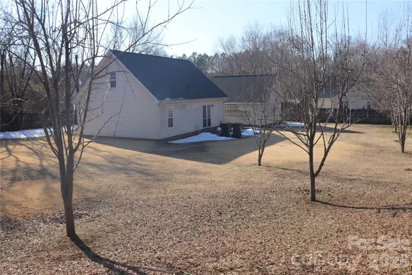 a backyard of a house with table and chairs