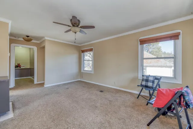 a view of a livingroom with a ceiling fan and window
