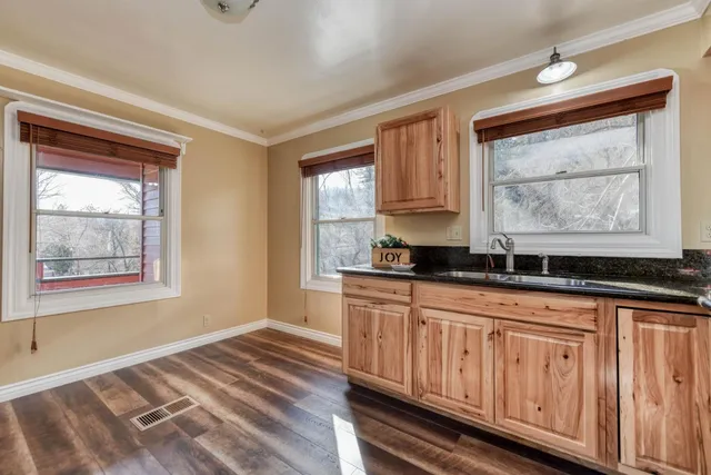 a view of hallway with wooden floor and closet