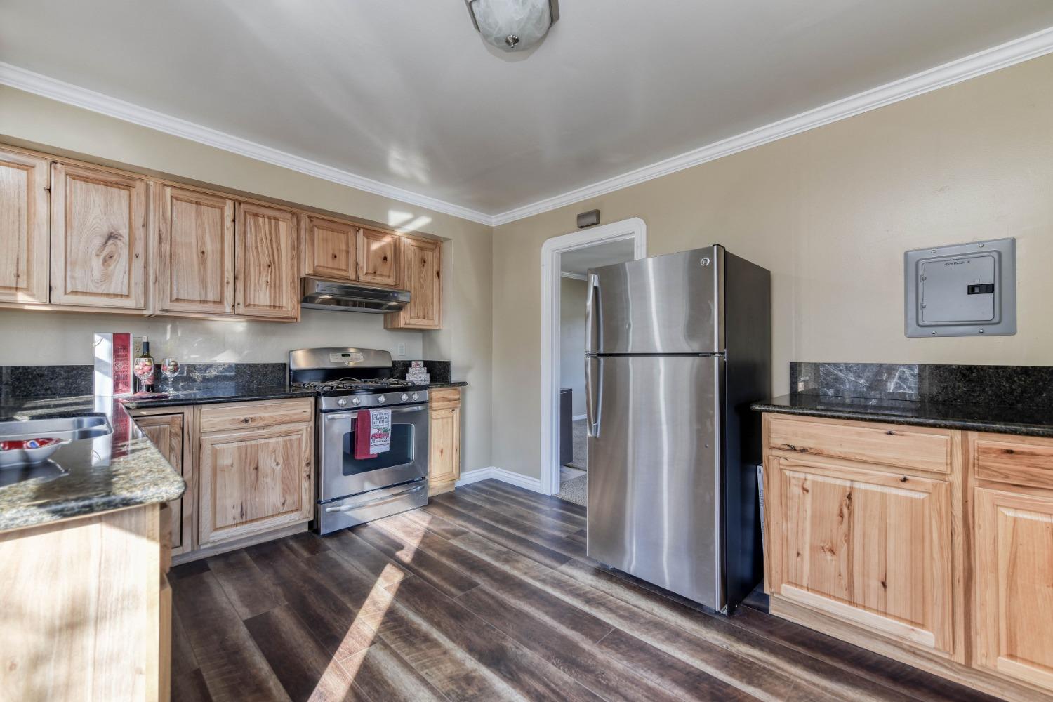 21335 Consolation Street Volcano, CA 95689 - Photo 23 of 41 a kitchen with granite countertop a refrigerator stove top oven and sink
