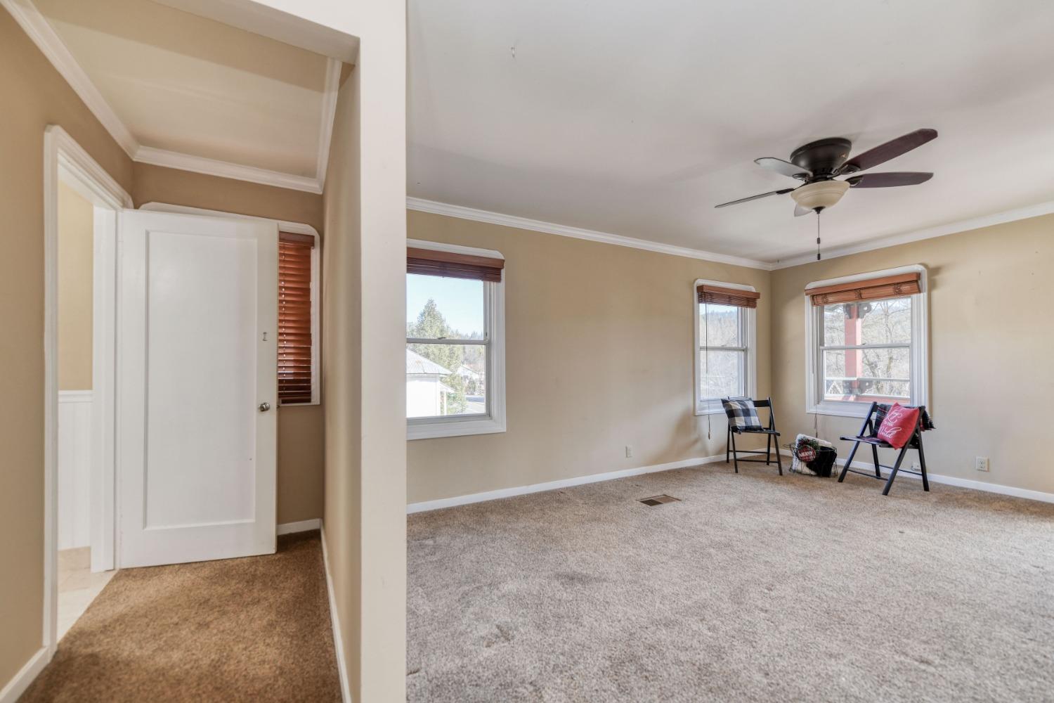 21335 Consolation Street Volcano, CA 95689 - Photo 30 of 41 a view of an empty room with window and a kitchen view
