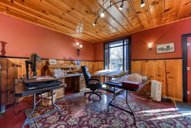 a living room with furniture a chandelier and a window