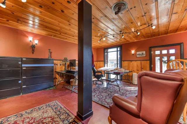 a living room with lots of furniture and a lamp