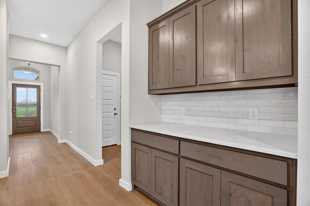 321 Skeen Peak Springtown, TX 76082 - Photo 19 of 37 Entryway featuring wood-finish flooring, recessed lighting, and a front door with an arched transom window