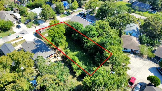 an aerial view of residential house with outdoor space and trees all around