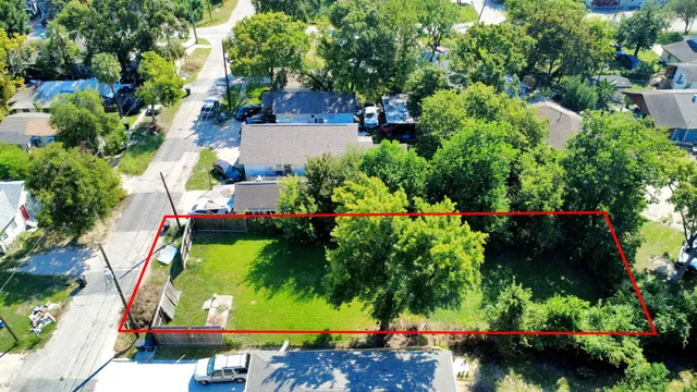 an aerial view of a house with a yard and lake view