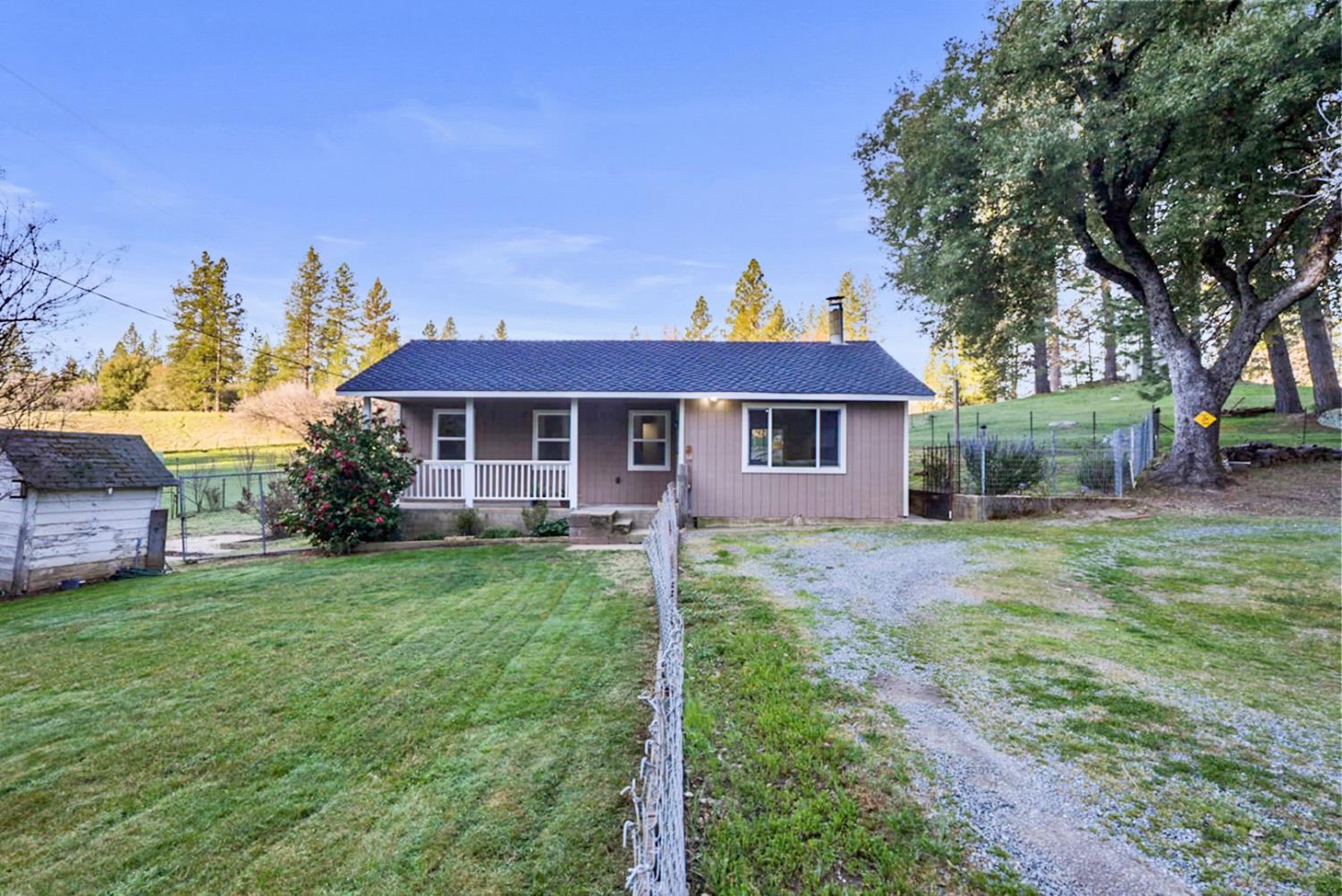 a front view of a house with a garden