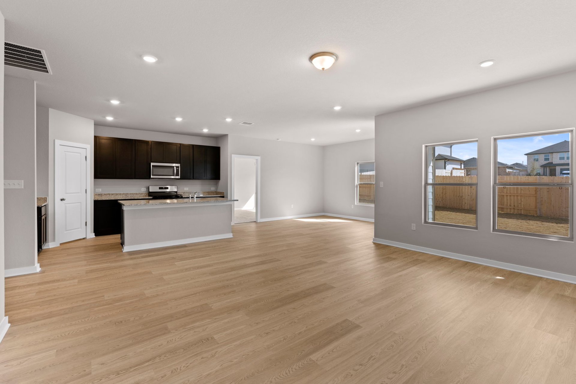 13613 Gray Landing Drive Elgin, TX 78621 - Photo 13 of 33 From Family Room to Open Concept Kitchen