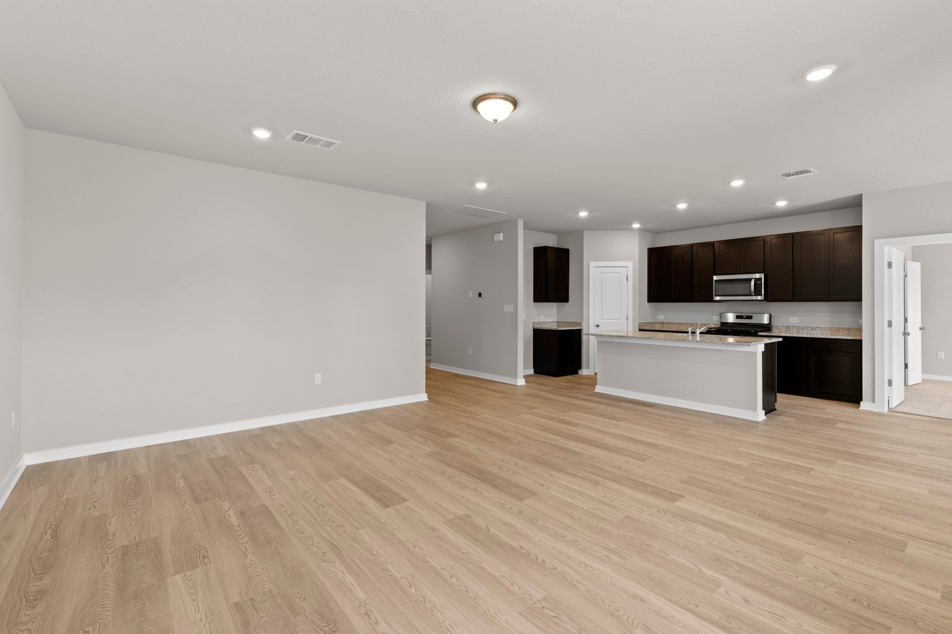 13613 Gray Landing Drive Elgin, TX 78621 - Photo 15 of 33 From Family Room to Open Concept Kitchen