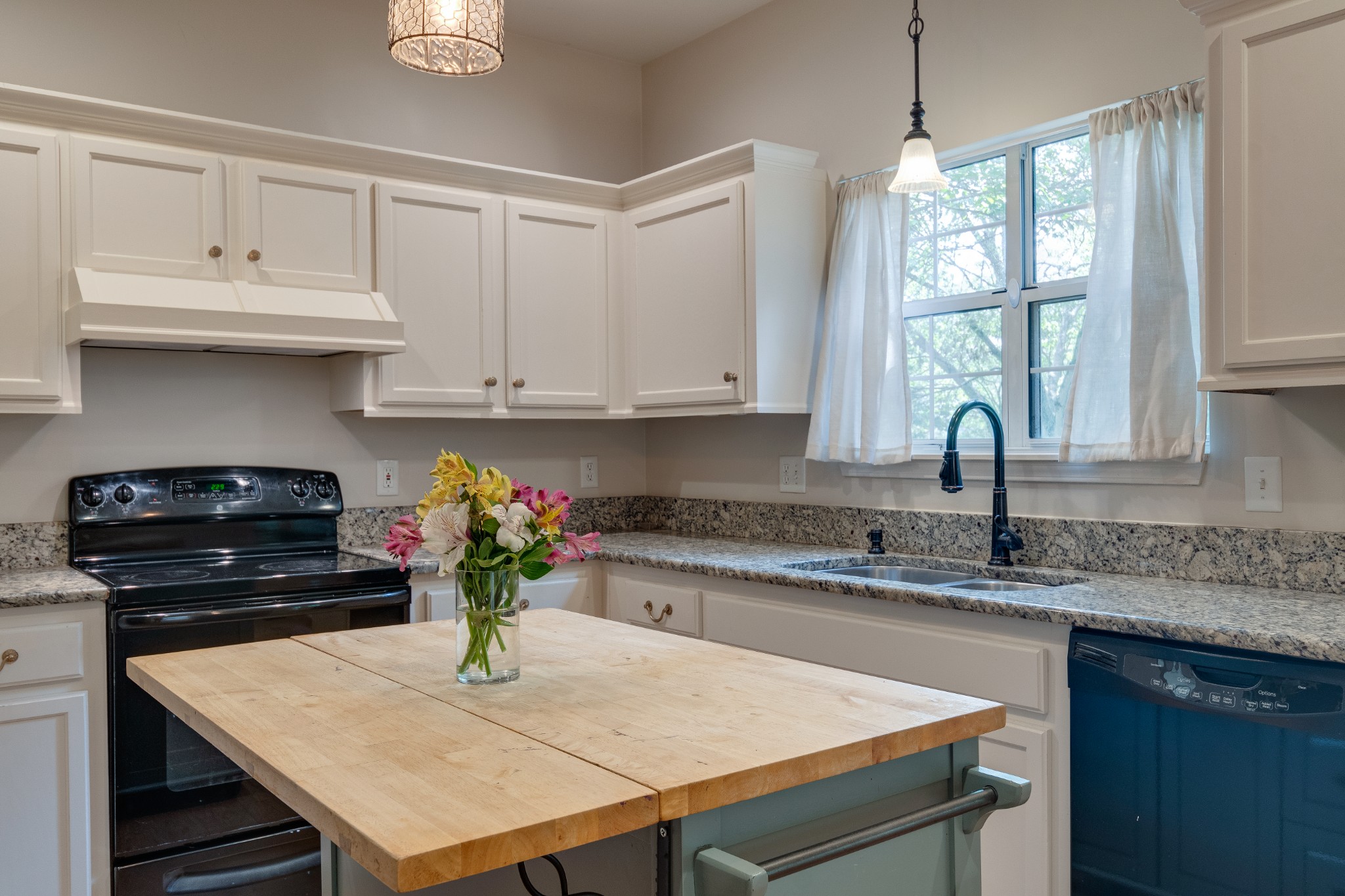 136 Cavalcade Circle Franklin, TN 37069 - Photo 11 of 31 a kitchen with stainless steel appliances granite countertop a stove a refrigerator a sink dishwasher with a dining table and chairs