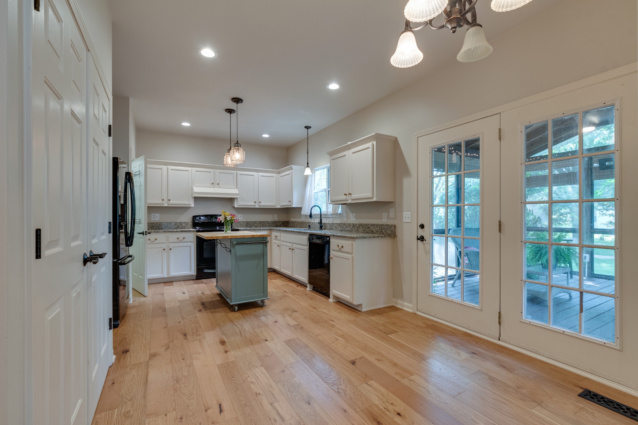 136 Cavalcade Circle Franklin, TN 37069 - Photo 9 of 31 a kitchen with stainless steel appliances kitchen island granite countertop a refrigerator a sink a stove and white cabinets