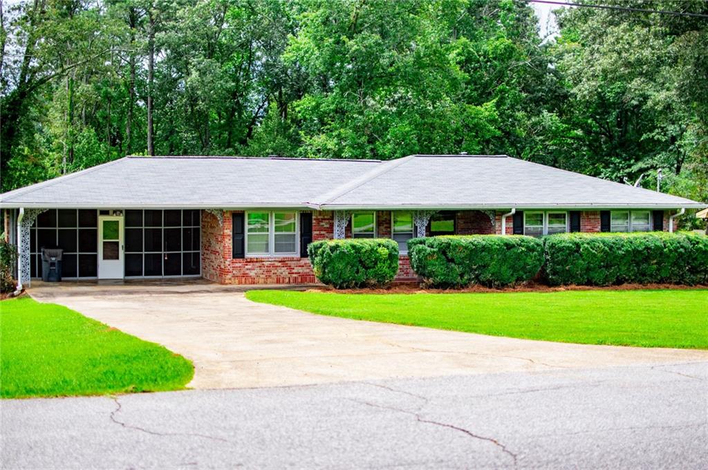 1711 Seayes Road Southwest Mableton, GA 30126 - Photo 1 of 1 a house with a garden and yard