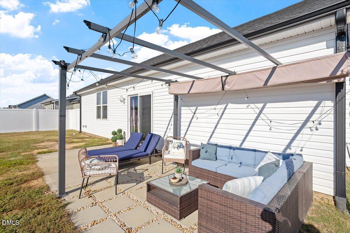 4045 Needham Road Bailey, NC 27807 - Photo 23 of 32 a living room with furniture and floor to ceiling windows