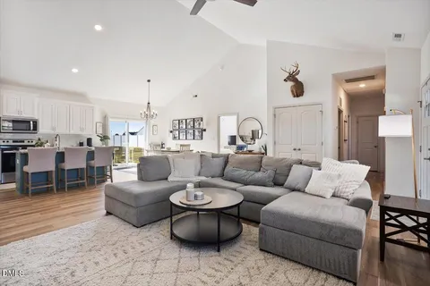 a living room with furniture and view of kitchen