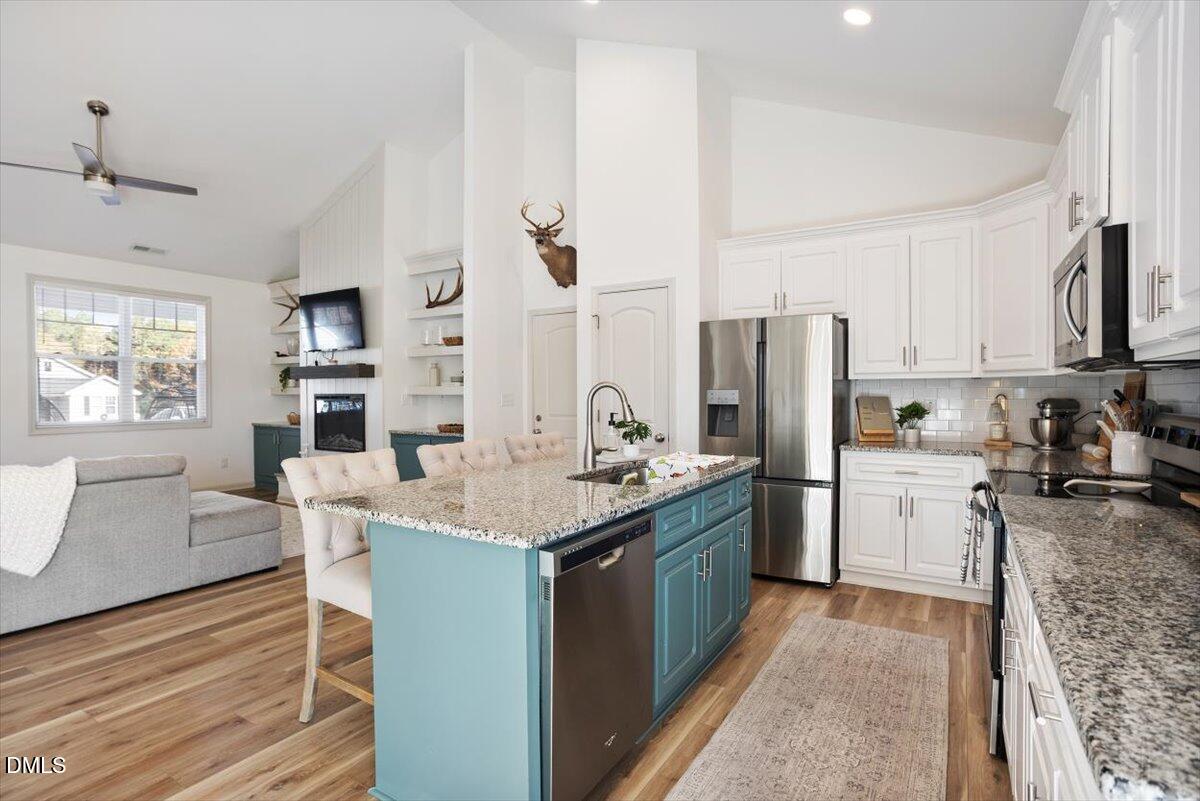 4045 Needham Road Bailey, NC 27807 - Photo 9 of 32 a kitchen with refrigerator cabinets and wooden floor