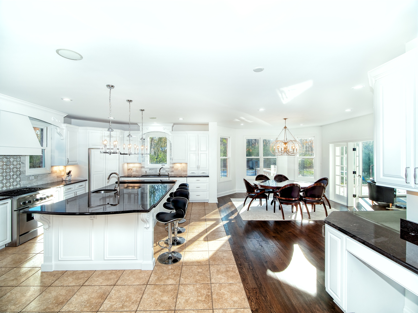 700 Timber Trail Riverwoods, IL 60015 - Photo 6 of 55 a kitchen with stainless steel appliances granite countertop a stove a sink a dining table and chairs with wooden floor