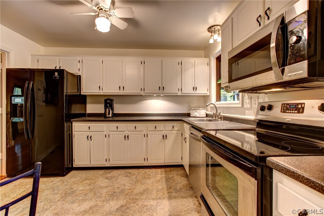1310 Black Heath Road Midlothian, VA 23113 - Photo 6 of 24 Bright kitchen with white cabinets and stainless s