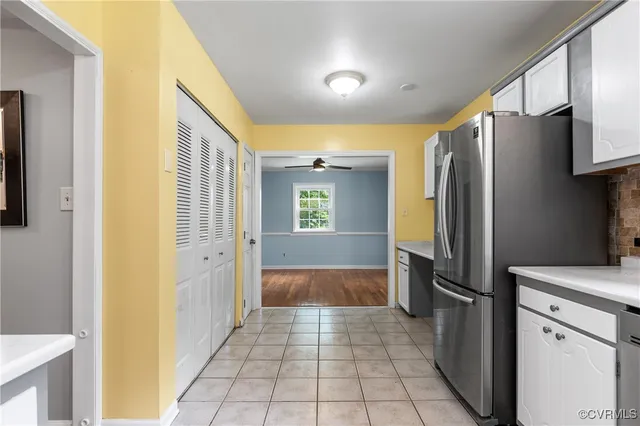 a kitchen with a refrigerator sink and cabinets
