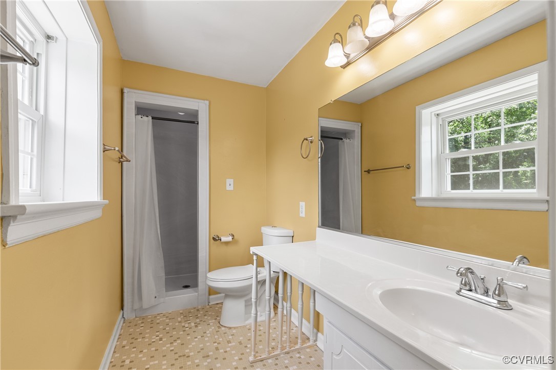 11911 Kilrenny Road Midlothian, VA 23113 - Photo 17 of 39 a bathroom with a sink a toilet and shower