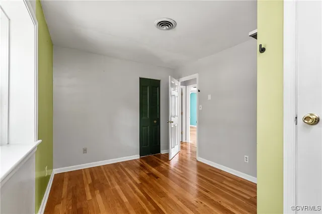 a view of a room with wooden floor