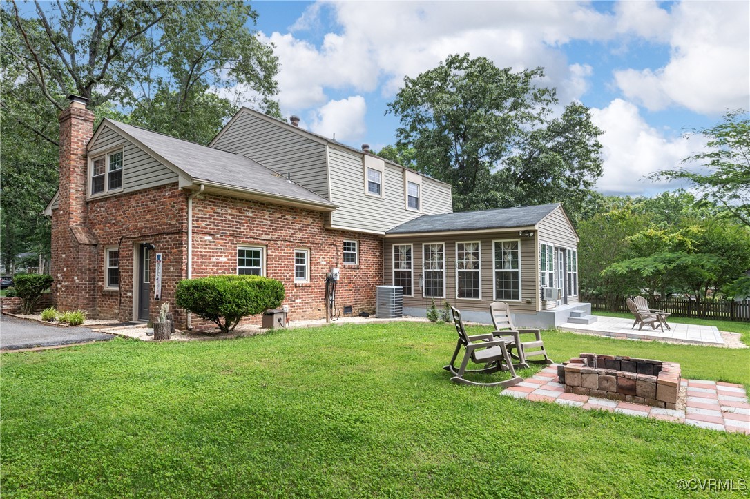 11911 Kilrenny Road Midlothian, VA 23113 - Photo 29 of 39 a front view of a house with a yard table and chairs