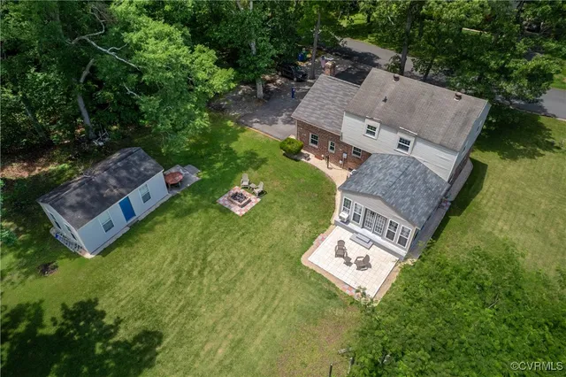 an aerial view of a house with a garden and trees