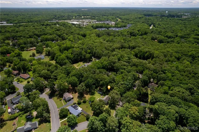 an aerial view of a houses with a yard