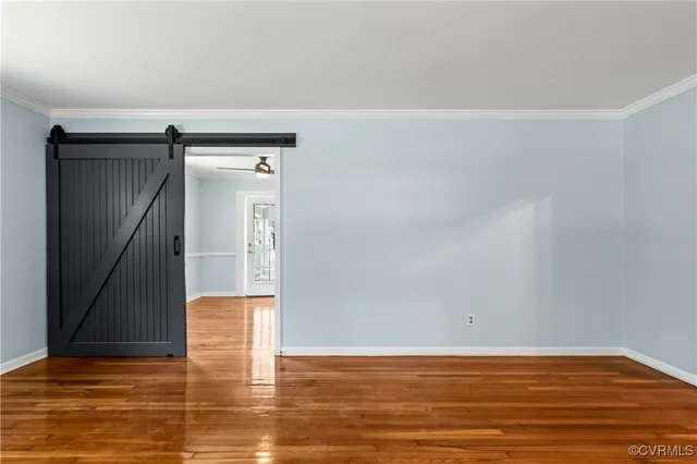 a view of empty room with wooden floor
