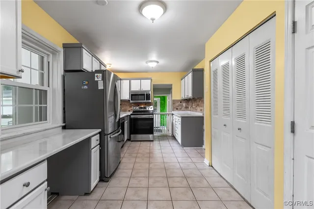 a kitchen with stainless steel appliances a refrigerator and a sink